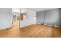 Bright living room features hardwood flooring, neutral paint, and sliding glass doors to a fenced backyard at 3341 W 94Th Ave, Westminster, CO 80031