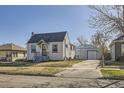 Charming single-story home with a well-maintained front yard and detached two car garage at 4354 Chase St, Denver, CO 80212