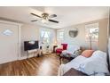 Cozy living room with hardwood floors, ceiling fan, and abundant natural light at 4354 Chase St, Denver, CO 80212