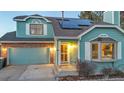 Front view of a teal two-story house with solar panels and landscaping at 13363 Cherry Ct, Thornton, CO 80241