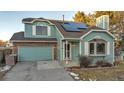 Two-story teal home with solar panels and attached garage at 13363 Cherry Ct, Thornton, CO 80241