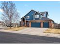 Charming two-story home featuring a three-car garage and a well-maintained front yard at 8346 Vivian St, Arvada, CO 80005