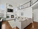 Bright living room with fireplace, built-ins, and large windows at 8346 Vivian St, Arvada, CO 80005