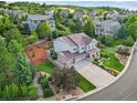 Breathtaking aerial view of an exquisite home on a meticulously landscaped lot backing to mature trees and lush landscaping at 2384 Crestridge Dr, Castle Rock, CO 80104