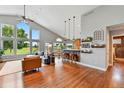 Open-concept living space with vaulted ceilings and seamless access to the kitchen at 6776 Salvia Ct, Arvada, CO 80007