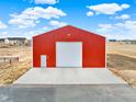 Detached garage with large roll-up door at 767 S Main St, Byers, CO 80103