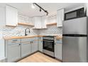 Updated kitchen with stainless steel appliances, sleek countertops, and stylish backsplash at 1155 N Ash St # 1206, Denver, CO 80220