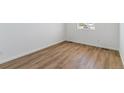 Bright bedroom with wood-look floors and a large window at 459 S Salida St, Aurora, CO 80017