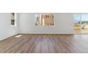 Open-concept living area with wood floors and ample natural light at 459 S Salida St, Aurora, CO 80017