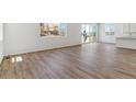 Open-concept living area with wood floors and ample natural light at 459 S Salida St, Aurora, CO 80017