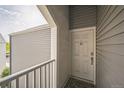 Balcony view of a white door with the letter D on gray siding at 3331 S Monaco Pkwy # D, Denver, CO 80222