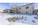Back of house showing a deck, stairs, and a large concrete patio at 7033 S Waterloo Way, Aurora, CO 80016