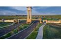 Aerial view of community entrance with clock tower and landscaping at 3408 N Duquesne Way, Aurora, CO 80019