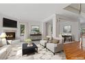 Bright living room features a fireplace, neutral colors, and an open floor plan with hardwood floors at 2660 S University Blvd # I, Denver, CO 80210