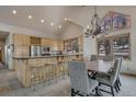 Bright kitchen with stainless steel appliances, breakfast bar, and adjacent dining area perfect for gatherings at 89 Fairview Cir, Breckenridge, CO 80424