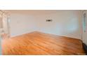 Bright living room features hardwood floors, white walls, and a wall-mounted TV bracket for easy entertainment setup at 558 N Washington St # 103, Denver, CO 80203