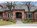 Charming brick home entrance with arched doorway and well-maintained landscaping at 5851 S Colorado Blvd, Greenwood Village, CO 80121