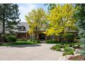 Charming brick home with a circular driveway and mature trees providing shade and curb appeal at 5851 S Colorado Blvd, Greenwood Village, CO 80121