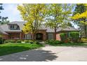 Beautiful brick home with a well-manicured lawn, mature trees and a welcoming front entrance at 5851 S Colorado Blvd, Greenwood Village, CO 80121