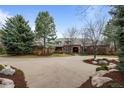 Lovely exterior of a brick home with a spacious front yard and mature trees at 5851 S Colorado Blvd, Greenwood Village, CO 80121