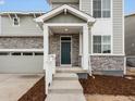 Inviting front entrance features stone accents, a covered porch, and a modern front door at 24008 E Atlantic Pl, Aurora, CO 80018