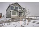 Angle view of home's exterior showcasing siding and lawn at 2848 Nectar St, Strasburg, CO 80136