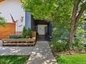 Inviting front entrance with a walkway leading to the door, complemented by beautiful landscaping at 5884 S Hanover Way, Greenwood Village, CO 80111