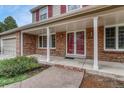 Welcoming covered front porch with brick columns and updated double-door entry at 7100 S Hudson Cir, Centennial, CO 80122