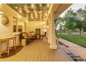 Inviting front porch with string lights and comfortable seating at 10876 Maple Rd, Lafayette, CO 80026