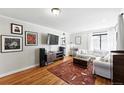 Inviting living room with hardwood floors, stylish decor, and abundant natural light at 1240 Ulster St, Denver, CO 80220