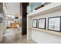 Inviting entryway showcasing art display with light-filled space, offering a glimpse into the open-concept living area at 35 S Forest St, Denver, CO 80246