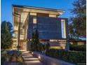 Modern home exterior featuring unique architectural design with a concrete and metal facade, complemented by manicured landscaping at 35 S Forest St, Denver, CO 80246