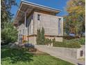 Well-maintained exterior of a modern residence with a unique concrete facade and mature trees surrounding the property at 35 S Forest St, Denver, CO 80246