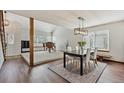 Open-concept living and dining area featuring hardwood floors, a neutral color palette, and plenty of natural light at 3311 E Euclid Ave, Centennial, CO 80121