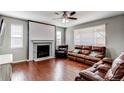 Comfortable living room with hardwood floors, a fireplace, and leather seating, perfect for relaxation at 25046 E Bayaud Pl, Aurora, CO 80018