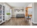 Bright living room featuring hardwood floors and built-in shelving at 1705 Peridot Ct, Castle Rock, CO 80108