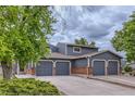 Beautifully kept home featuring a three-car garage, brick accents, and mature landscaping at 12682 Fairfax St, Thornton, CO 80241