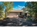 Exterior shot with large front driveway and mature trees at 947 Dogwood Dr, Golden, CO 80401