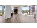Bright living room features wood floors and large windows with views of the cityscape at 3100 E Cherry Creek South Dr # 1101, Denver, CO 80209