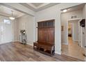 Inviting entryway with wood floors, hall tree, and views into other living spaces at 2200 Cadman St, Berthoud, CO 80513