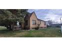 Charming brick home featuring a well-maintained lawn and mature trees, creating a cozy curb appeal at 9120 Elm Ct, Denver, CO 80260