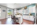Bright kitchen featuring a large island, stainless steel appliances, and access to the outdoor deck at 20855 Omaha Ave, Parker, CO 80138