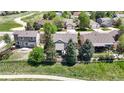 Aerial view of a home showcasing its backyard, fencing, landscaping, and proximity to green spaces at 20855 Omaha Ave, Parker, CO 80138