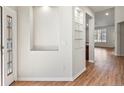 Bright foyer with hardwood flooring and built-in display shelves offering a modern and stylish welcome at 8579 S Miller Way, Littleton, CO 80127