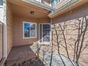 Welcoming front porch with tiled floor and a stylish front door offering a cozy entrance at 8579 S Miller Way, Littleton, CO 80127