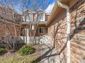 Inviting townhouse front yard with manicured lawn and charming white picket fence showcasing suburban appeal at 8579 S Miller Way, Littleton, CO 80127