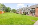 Row of well-maintained townhomes with manicured green lawn at 15149 E Princeton Pl # B, Aurora, CO 80014
