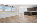 Sun-filled living area with hardwood floors and a view of the spacious backyard at 995 Pinehurst Ct, Bennett, CO 80102
