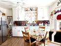 Bright eat-in kitchen with white cabinets, stainless steel appliances, and a cozy dining area at 1516 S Lowell Blvd, Denver, CO 80219