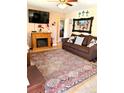 Inviting living room with a fireplace, TV, sofa, and patterned rug, perfect for relaxing or entertaining at 1516 S Lowell Blvd, Denver, CO 80219